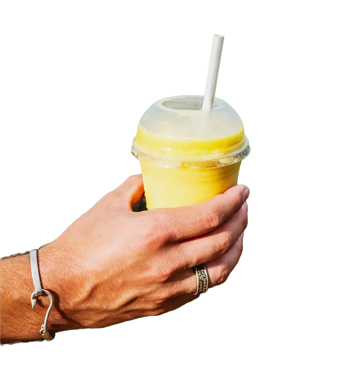 Hand holding a bright yellow tropical smoothie at Drifters