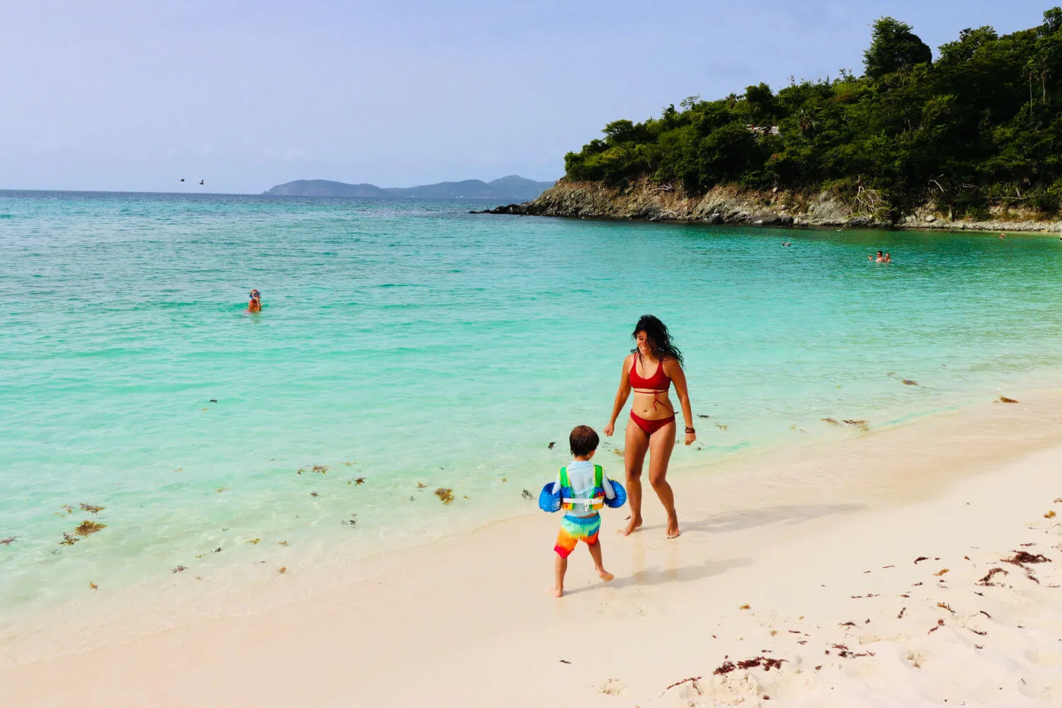 Family enjoying a calm St. John beach with children